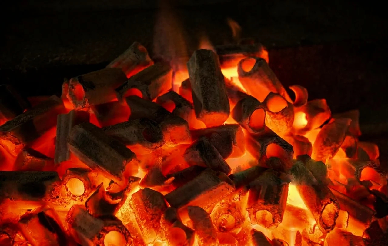 Glowing charcoal embers in a barbecue application